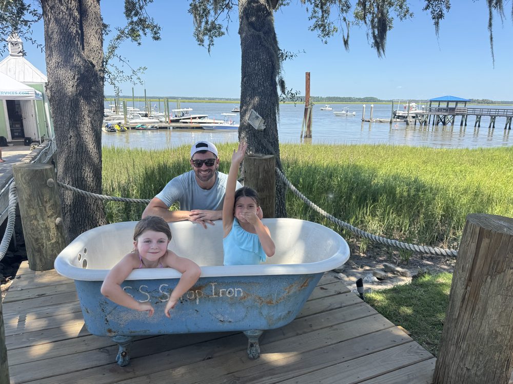 Chris and his girls on the dock by the marsh